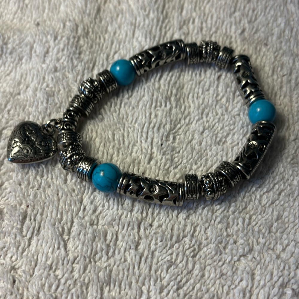 Silver tone with heart, engraved pendant & turquoise beads. Stretchy & 8”.
